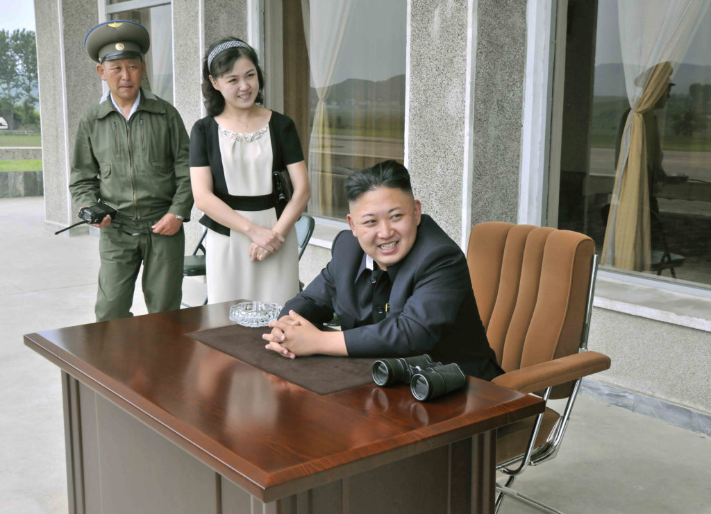 KCNA picture shows North Korean leader Kim and his wife Ri during a visit to Unit 1017 of KPA Air and Anti-Air Force