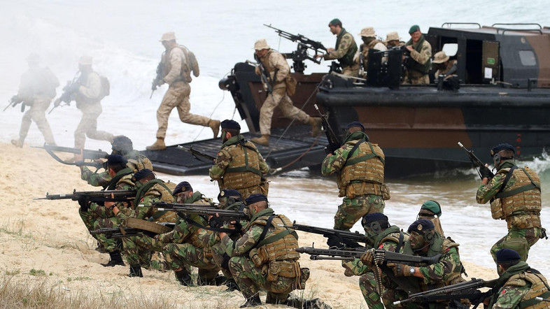 British Royal Marines and Portuguese fuzileiros, exit amphibious boats during the NATO Trident Juncture exercise 2015 in Troia, south of Lisbon, Thursday, Nov. 5, 2015. NATO Allies and partner nations join forces during three weeks for the Alliance's Trident Juncture live military exercise involving 36,000 troops from more than 30 nations across Portugal, Italy and Spain. (AP Photo/Steven Governo)