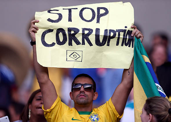 A fan holds up a sign reading "Stop Corruption" during the FIFA Confederations Cup Brazil 2013 Group A match between Japan and Mexico at Estadio Mineirao on June 22, 2013 in Belo Horizonte, Brazil.