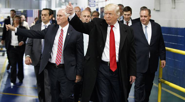 FILE - In this Dec. 1, 2016, file photo, President-elect Donald Trump and Vice President-elect Mike Pence wave as they visit to Carrier factory in Indianapolis, Ind. Donald Trump enters the White House on Jan. 20 just as he entered the race for president: defiant, unfiltered, unbound by tradition and utterly confident in his chosen course. In the 10 weeks since his surprise election as the nation’s 45th president, Trump has violated decades of established diplomatic protocol, sent shockwaves through business boardrooms, tested long-standing ethics rules and continued his combative style of replying to any slight with a personal attack _ on Twitter and in person. (AP Photo/Evan Vucci, File)