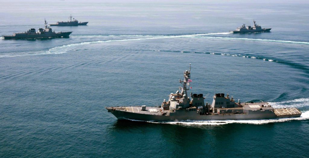 epa04998020 A handout photo released by the US Navy dated 25 May 2015 of the guided-missile destroyer USS Lassen (front) conducting a trilateral naval exercise with the Turkish and South Korean Navy in support of theater security operations in waters to the south of the Korean Peninsula. The destroyer USS Lassen sailed within 12 nautical miles of Subi Reef in the Spratly archipelago, one of the areas where Beijing has allegedly been building artificial islands, according to media reports on 27 October 2015.  EPA/NAVAL AIR CREWMAN EVAN KENNY / U  HANDOUT EDITORIAL USE ONLY