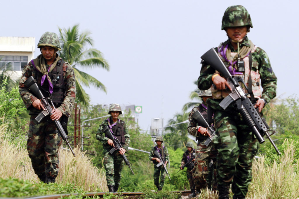 Thai security forces patrol the railway in the troubled southern province of Yala March 27, 2013. The first round of formal peace talks between Thai government and the insurgent group Barisan Revolusi Nasional (BRN) will take place on March 28 and will be mediated by Malaysia. Although the first round is set for Thursday, there has been no halt in the fighting and people in the region see no early end to one of Southeast Asia's bloodiest conflicts.     REUTERS/Surapan Boonthanom (THAILAND - Tags: CIVIL UNREST CONFLICT MILITARY POLITICS) - RTXXZ90